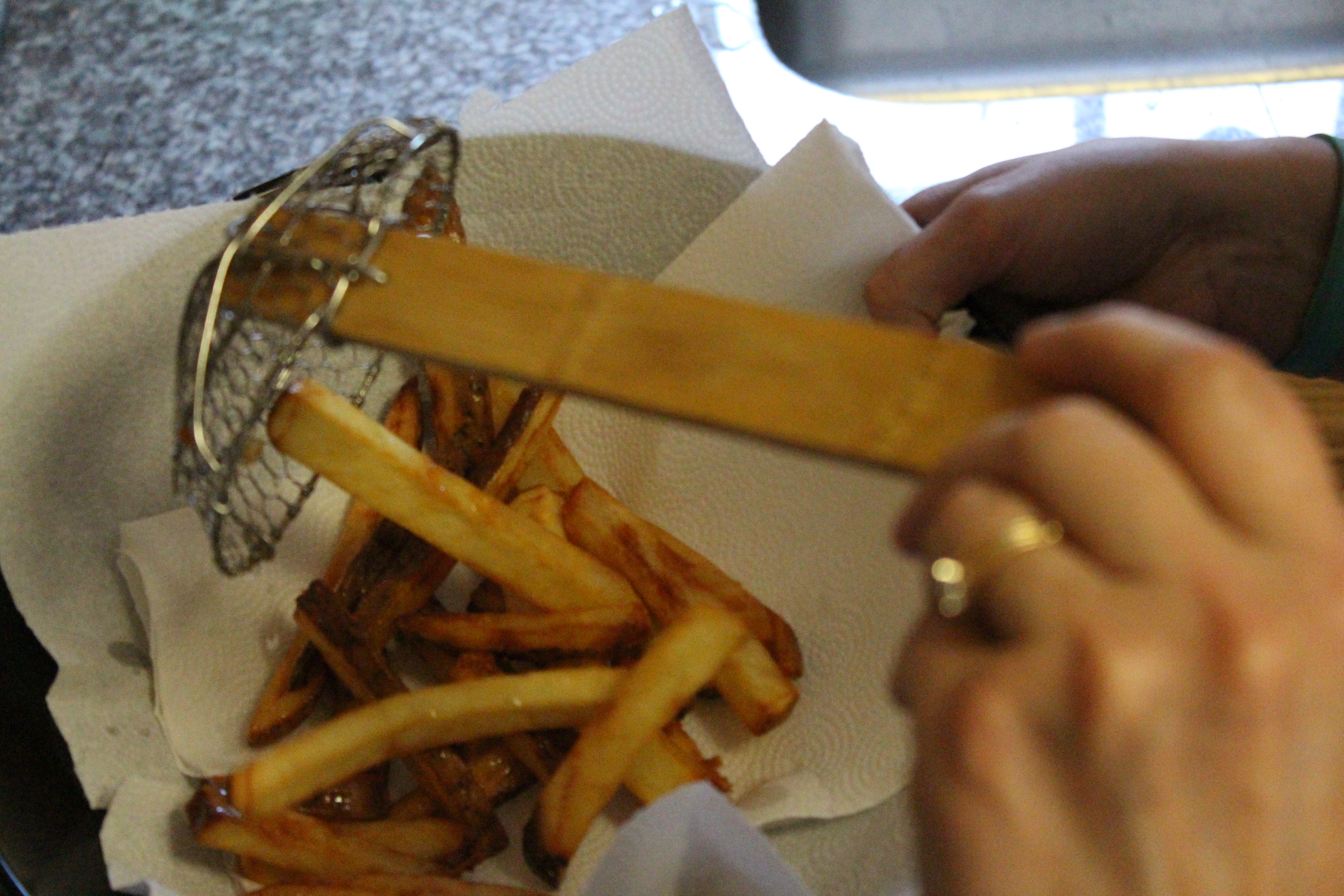 taking french fries out of the oil