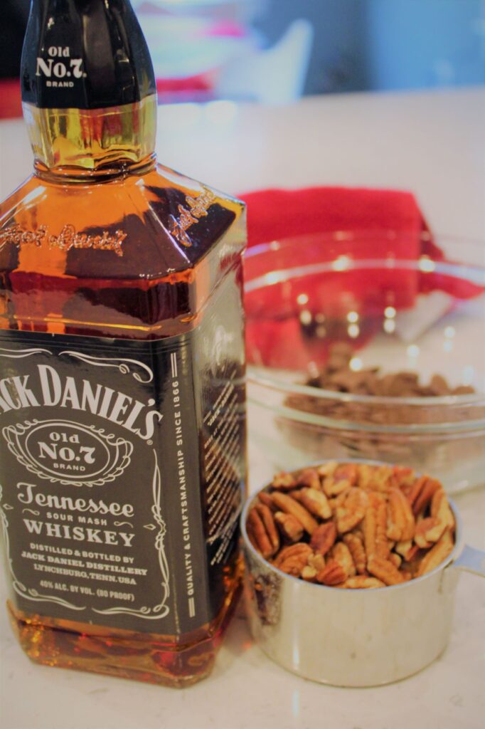 Ingredients for Jack Daniel's cake; whiskey, pecans and brown sugar